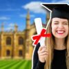 Woman holding her degree peace sign