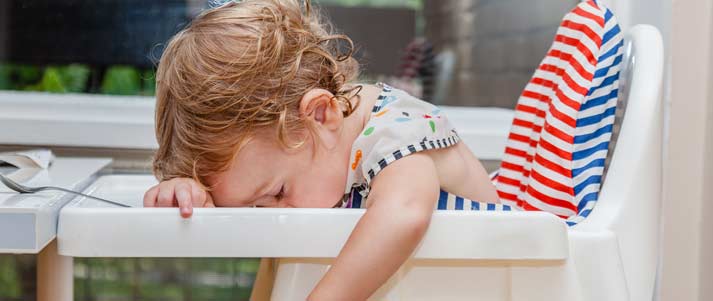 bebé dormido en una silla alta