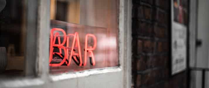 A neon red sign that says 'bar' in Manchester, UK