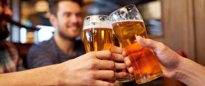 people clinking beer glasses