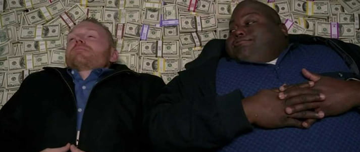 two breaking bad characters lying on a pile of money