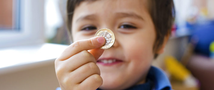 child holding pound coin