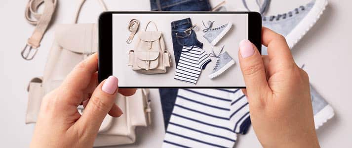 Woman taking a picture of clothes with phone