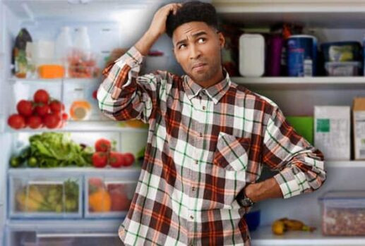 confused man in front of fridge and cupboard