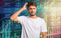 confused man in front stock market charts