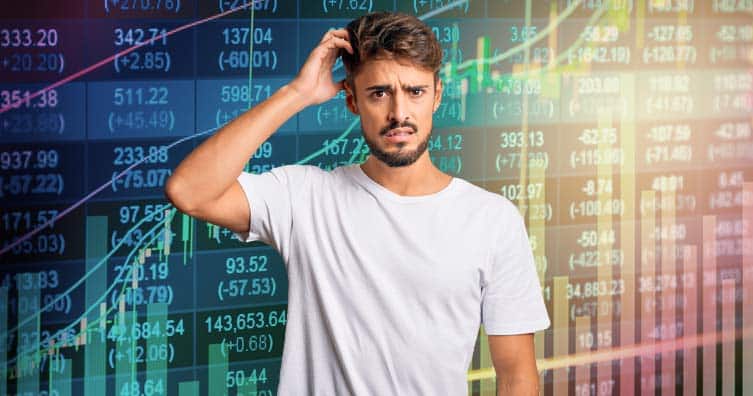 verwarde man in front stock market charts