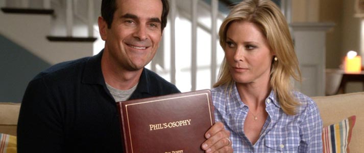 Couple from Modern Family holding Phil's-osophy book
