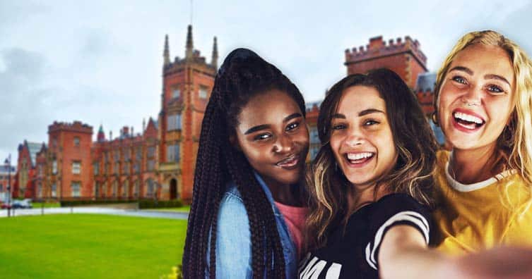 three women taking selfie in front of a university