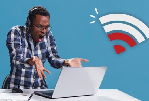 man frustrated at laptop next to wifi symbol