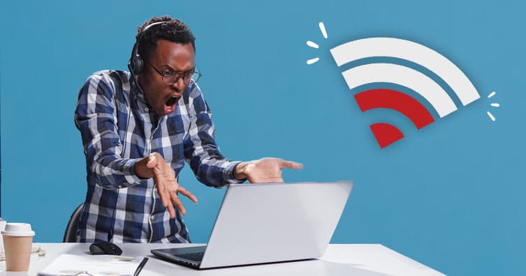 man frustrated at laptop next to wifi symbol