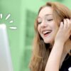 happy woman smiling looking at a laptop