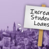 placard saying "increase student loans" in front of protest