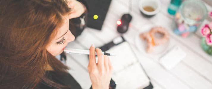 woman working with pen and notepad