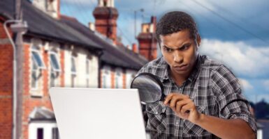 man using magnifying glass with terrace background