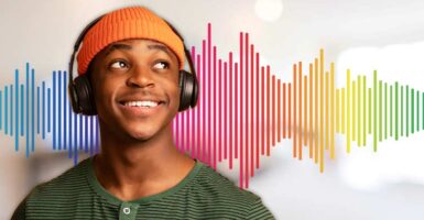 man using headphones in front of colourful soundwave