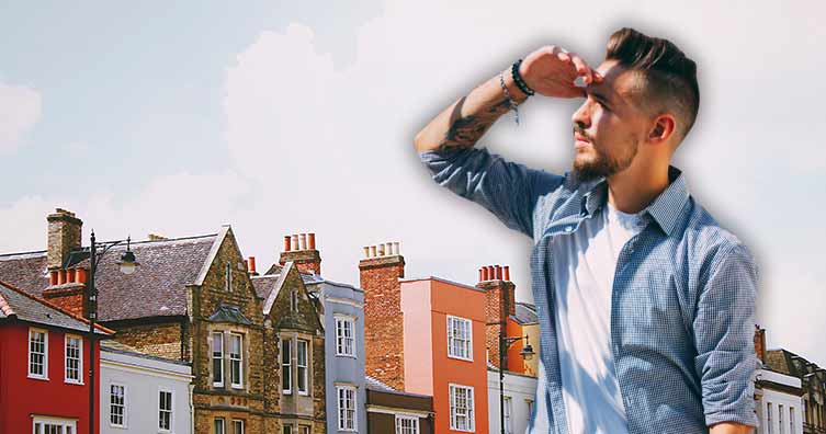 young man looking at houses