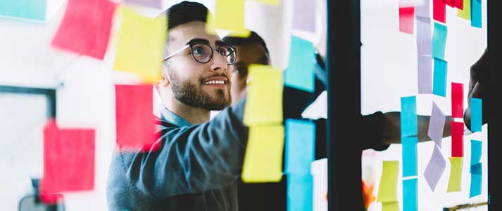 Man at work using post it notes