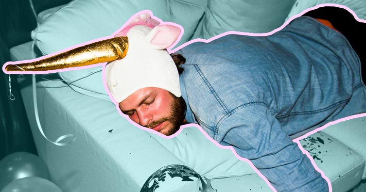 man wearing unicorn hat passed out drunk on sofa