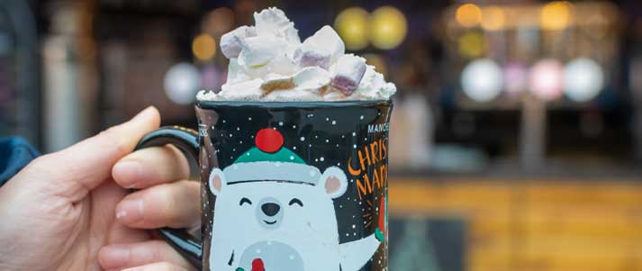 A person holding a hot chocolate at Manchester Christmas Market