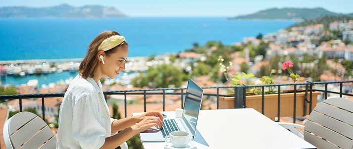 Girl working on laptop with a view