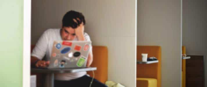 stressed young person using laptop