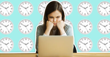 Stressed unhappy angry girl laptop clocks wall time desk