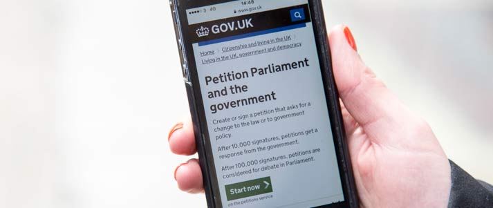 phone with uk petition website on screen