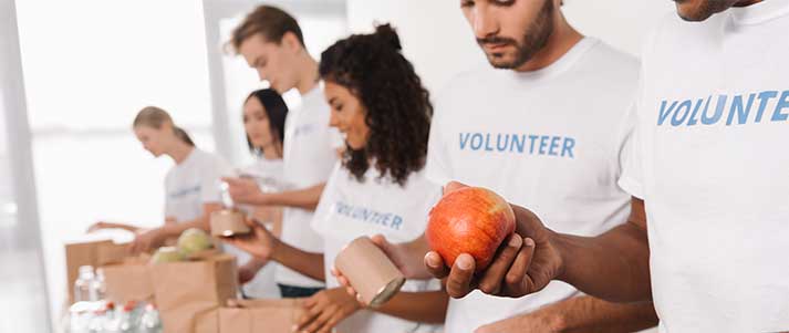 Group of volunteers packing food