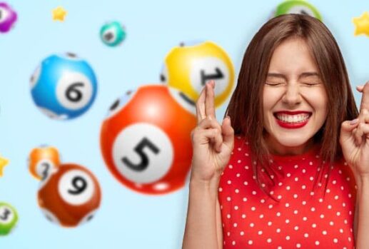 woman crossing fingers in front of lottery balls