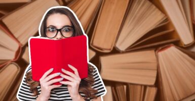 Woman-looking-over-book-reading-textbooks