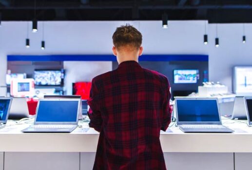 young person looking at laptops