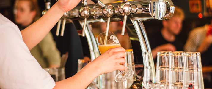 man pouring pint