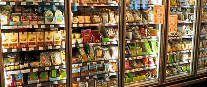 supermarket freezer shelves filled with food