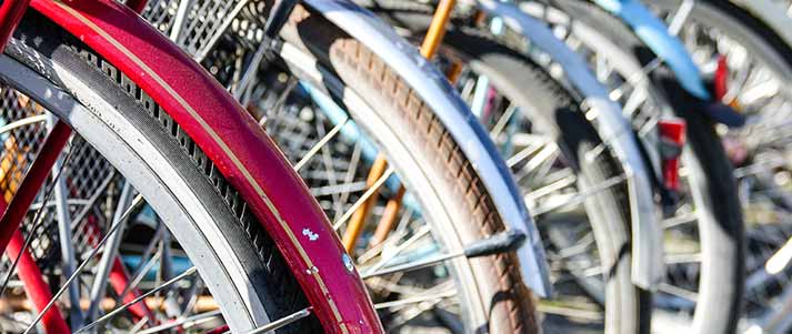 wheels in a row with fenders on the tires