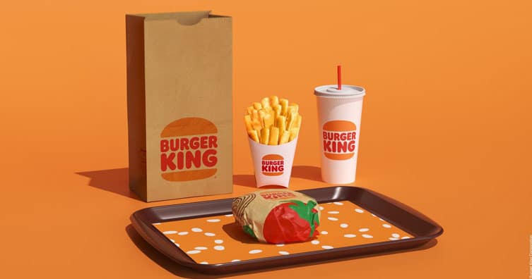 burger king burger on tray with fries cups with straws paper bag