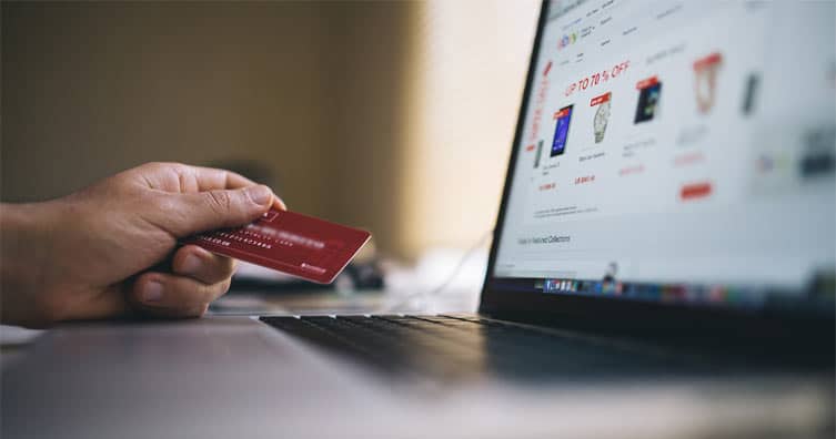 person holding credit card shopping online