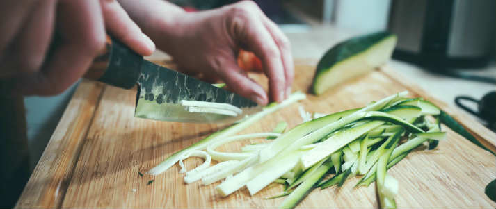 person chopping vegetable