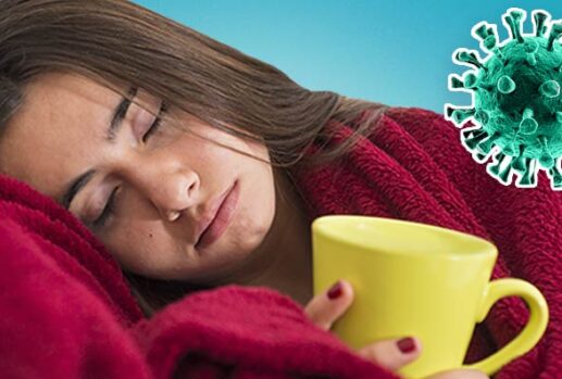 Woman in blanket with mug and coronavirus germ