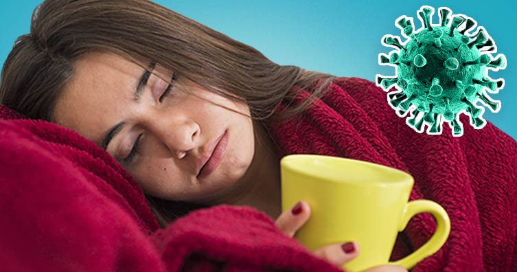 Woman in blanket with mug and coronavirus germ