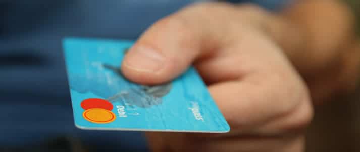 man holding a debit card
