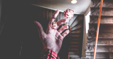 Dice being rolled above a grimy stairwell
