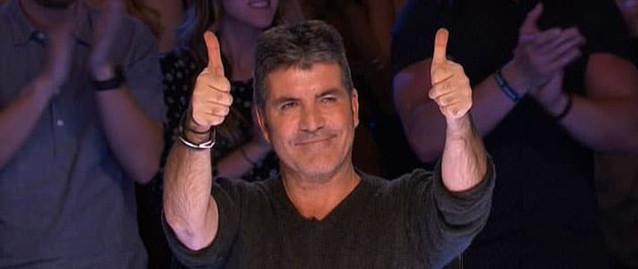 Simon Cowell holding two thumbs up