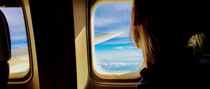 person looking out of plane window