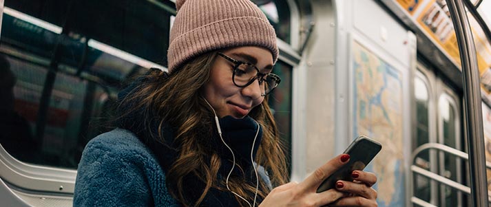 girl-listening-to-music-on-public-transport-with-headphones