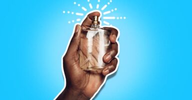 Hand holding perfume