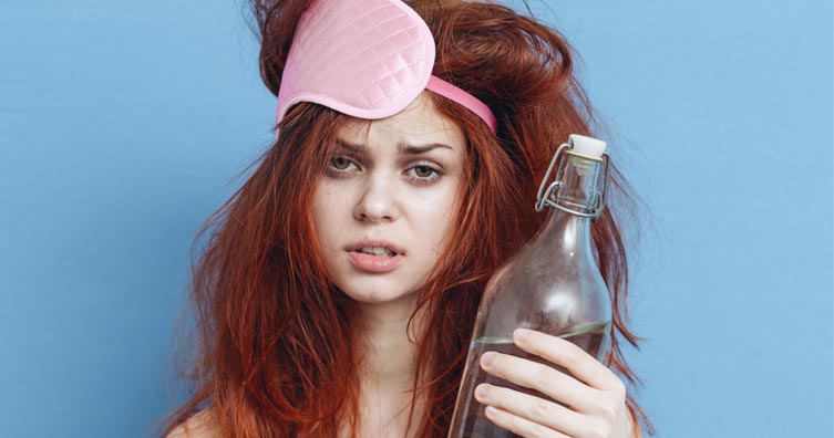 girl hungover with water bottle