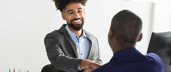 smartly dressed men shaking hands