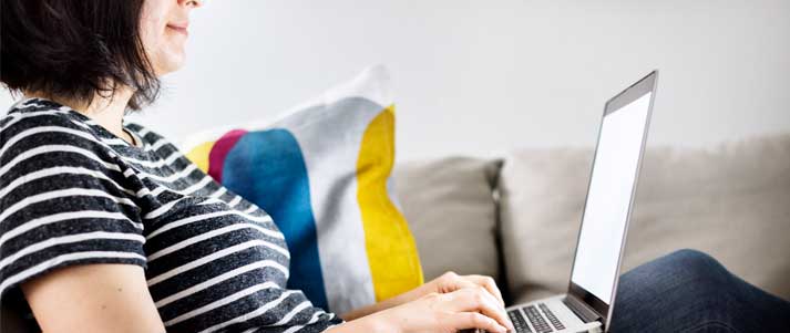 woman on laptop on sofa