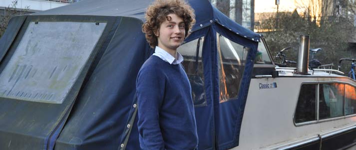 student next to a houseboat in London