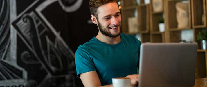 Man looking happy at laptop